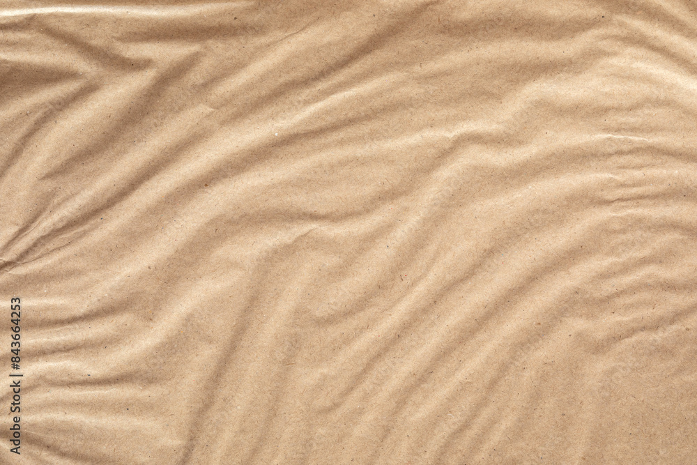 A close-up image of brown paper with a wrinkled texture. The paper is light brown in color and has a natural, organic feel. A close-up image of brown paper with a wrinkled texture. The paper is light brown in color and has a natural, organic feel.