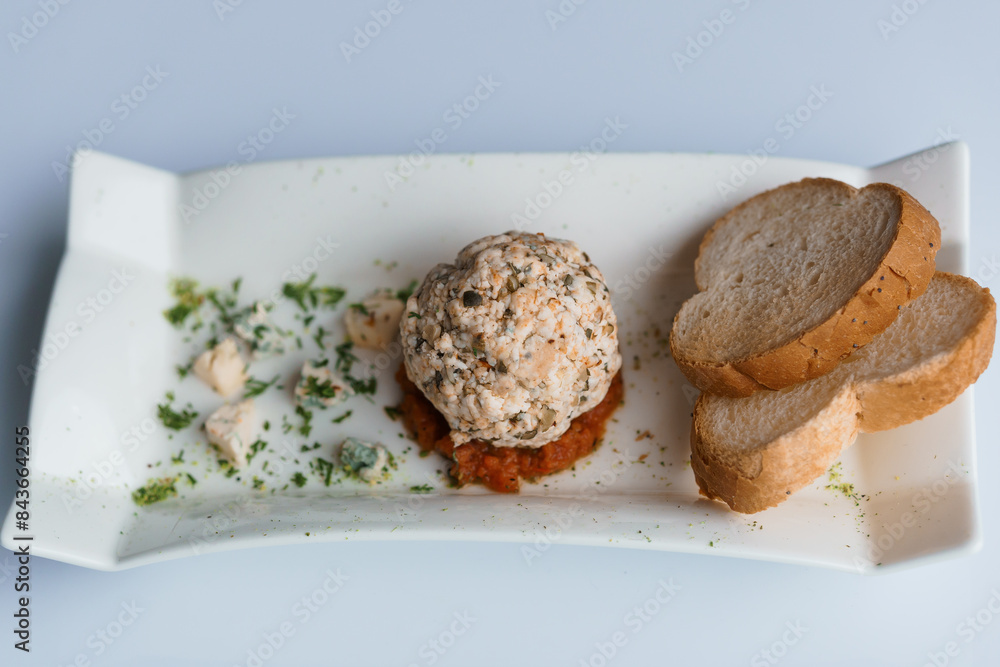 Cheese balls with herbs on a black board on a white background Cheese balls with herbs on a black board on a white background