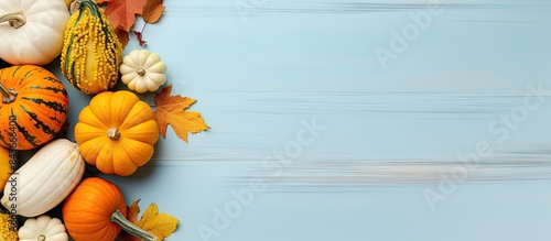 Thanksgiving day Flat lay composition with pumpkins on light blue wooden table space for text. copy space available