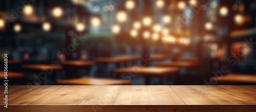 Empty wooden table space platform and blurred resturant or coffee shop background for product display montage. copy space available © Gular