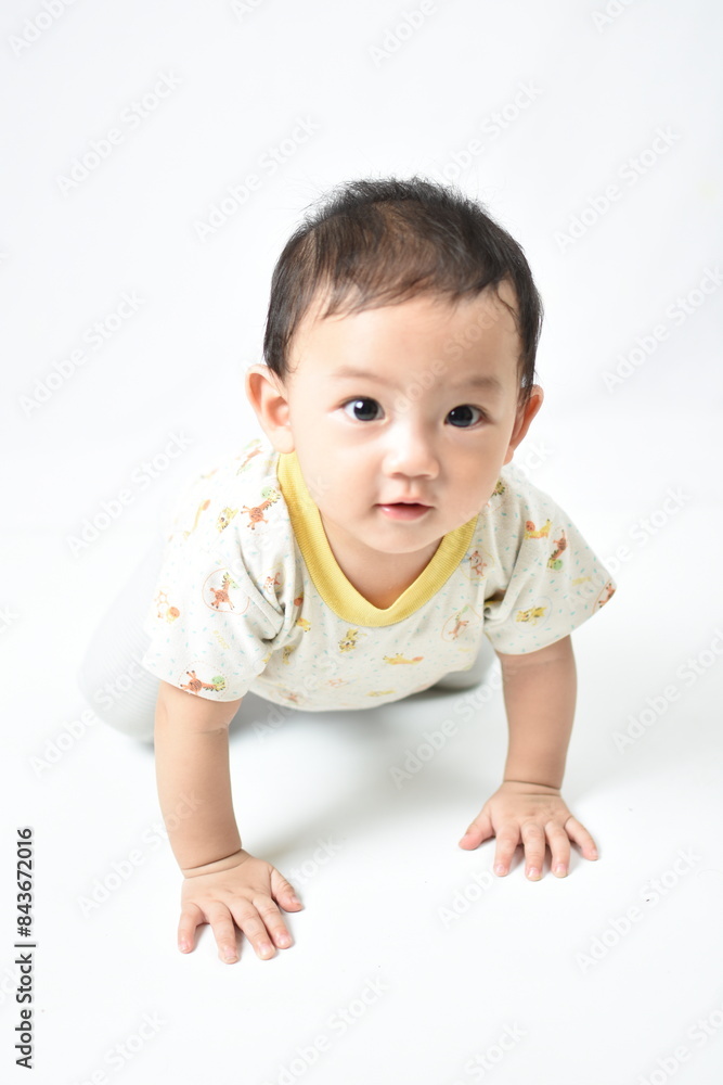 Adorable baby crawling on a white background, looking curiously at the camera with big, bright eyes and a sweet smile. Dressed in a cute patterned shirt, showcasing innocence and curiosity. Adorable baby crawling on a white background, looking curiously at the camera with big, bright eyes and a sweet smile. Dressed in a cute patterned shirt, showcasing innocence and curiosity.