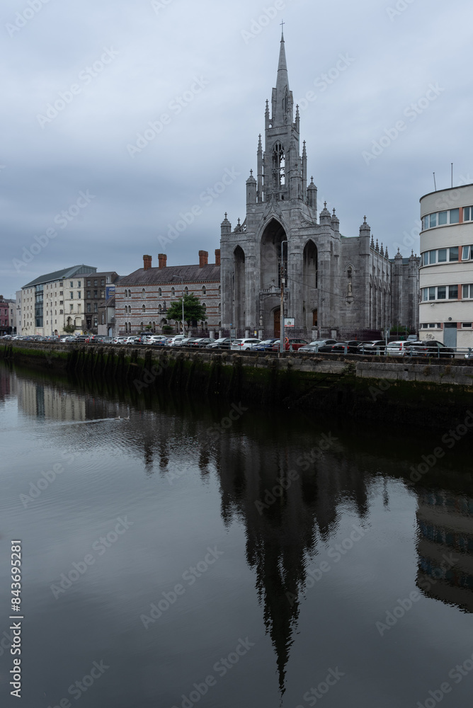Fototapeta premium Urban cityscape of Cork city holy trinity church river Lee. Ireland Europe.