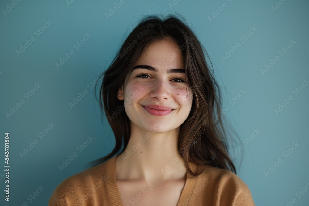 A close up portrait of a young woman with a subtle smile A close up portrait of a young woman with a subtle smile