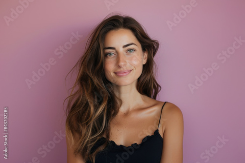 A close up portrait of a young woman with a subtle smile