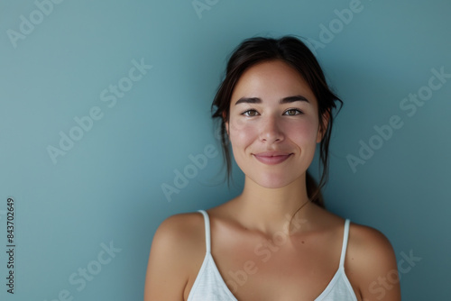A close up portrait of a young woman with a subtle smile