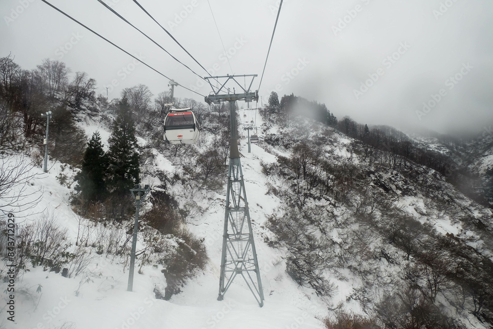 Cable car in Caucasus mountains in a snow blizzard at cold winter day Cable car in Caucasus mountains in a snow blizzard at cold winter day