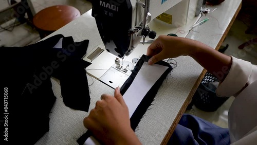 Close-up video, the process of sewing or combining clothing components that have been cut into clothes in a clothing factory. 