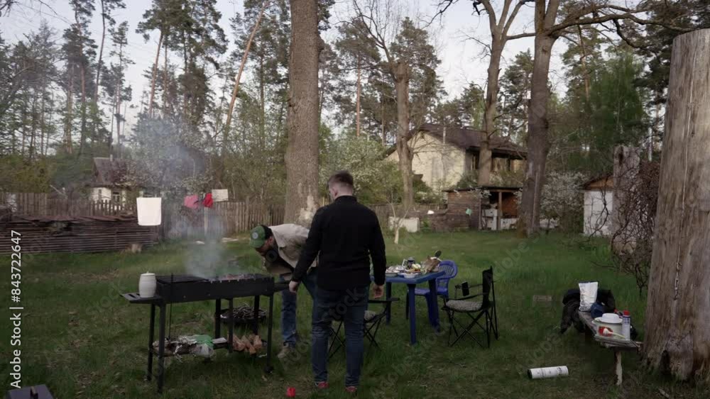 Guys cooking food on the grill Guys cooking food on the grill