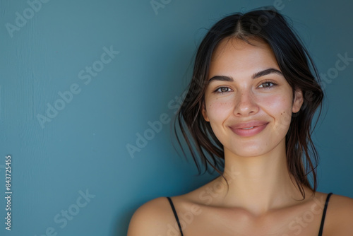 A close up portrait of a young woman with a subtle smile