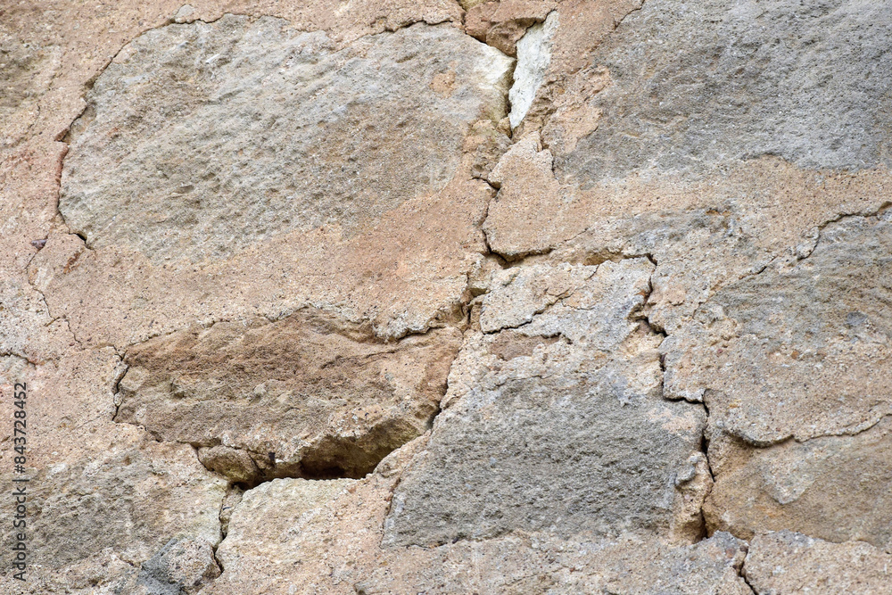 Big crack. Large winding deep crack in an old stone plastered wall. Close-up. Selective focus. Copy space.