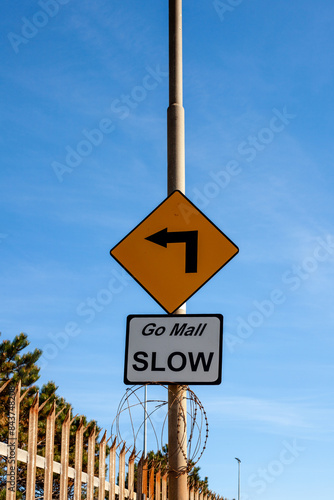 Go Slow road sign on a lamp post