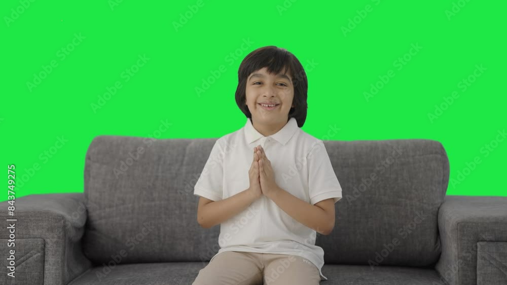 Cute Indian boy doing Namaste and greetings Green screen Cute Indian boy doing Namaste and greetings Green screen