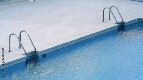 a pool without bathers with two stairs