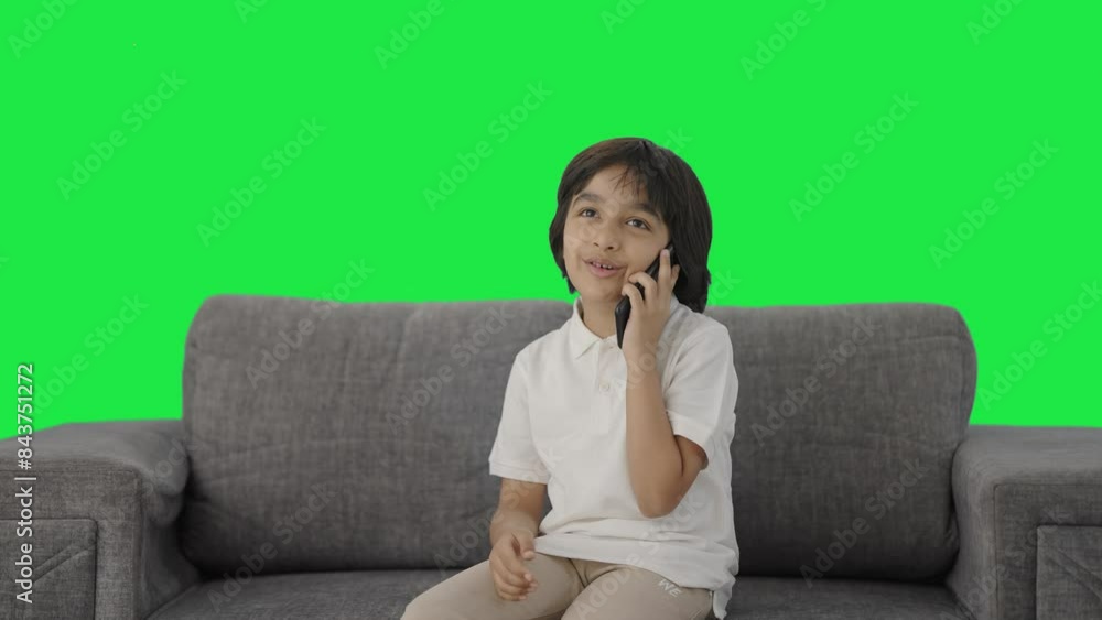 Happy Indian boy talking on phone Green screen Happy Indian boy talking on phone Green screen