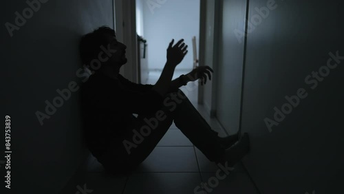 depressed man sitting on floor sad unhappy person holding forehead suffering