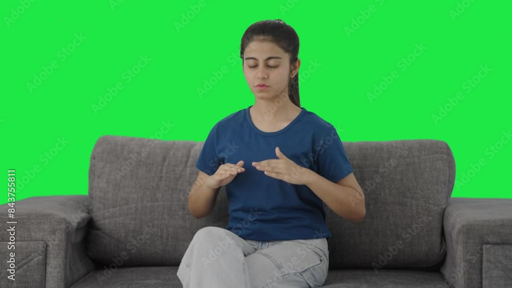 Indian teenage girl doing breathe in breathe out exercise Green screen Indian teenage girl doing breathe in breathe out exercise Green screen