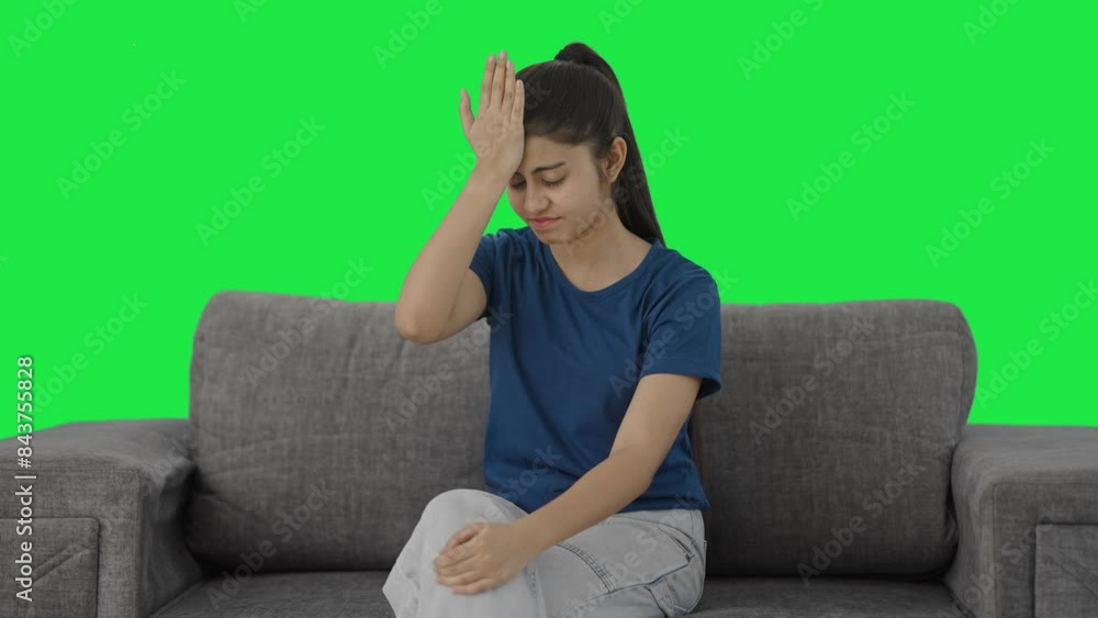 Frustrated Indian teenage girl slapping her head Green screen