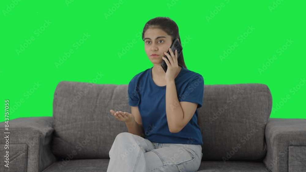 Serious Indian teenage girl talking on call Green screen Serious Indian teenage girl talking on call Green screen