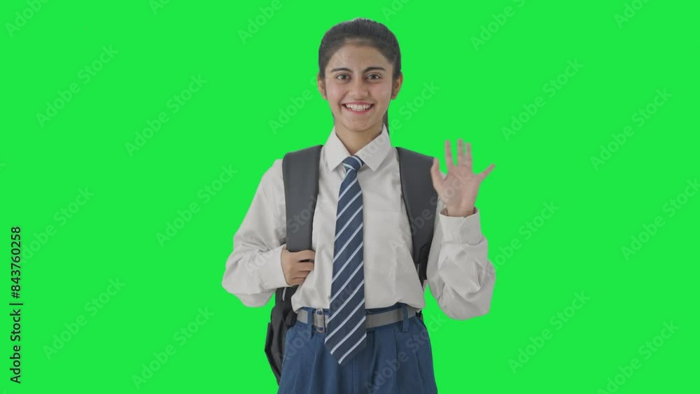 Happy Indian school girl saying Hello to the camera Green screen Happy Indian school girl saying Hello to the camera Green screen