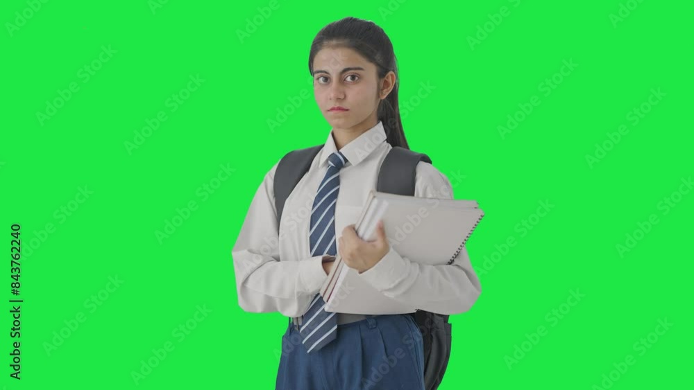 Portrait of Confident Indian school girl standing with books Green screen Portrait of Confident Indian school girl standing with books Green screen