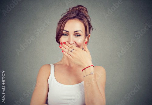young shy woman smiling and playfully looking at camera