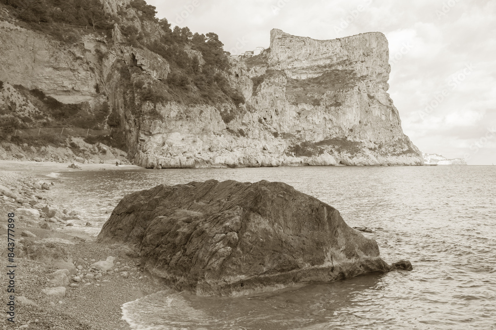 Landscape View at Moraig Cove Beach with Rock; Alicante; Spain in Black and White Sepia Tone