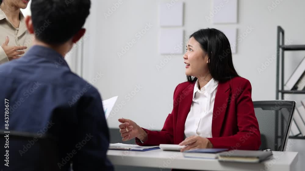 Businesswoman talking during a meeting with colleagues to discuss planning new business projects. Businesswoman talking during a meeting with colleagues to discuss planning new business projects.