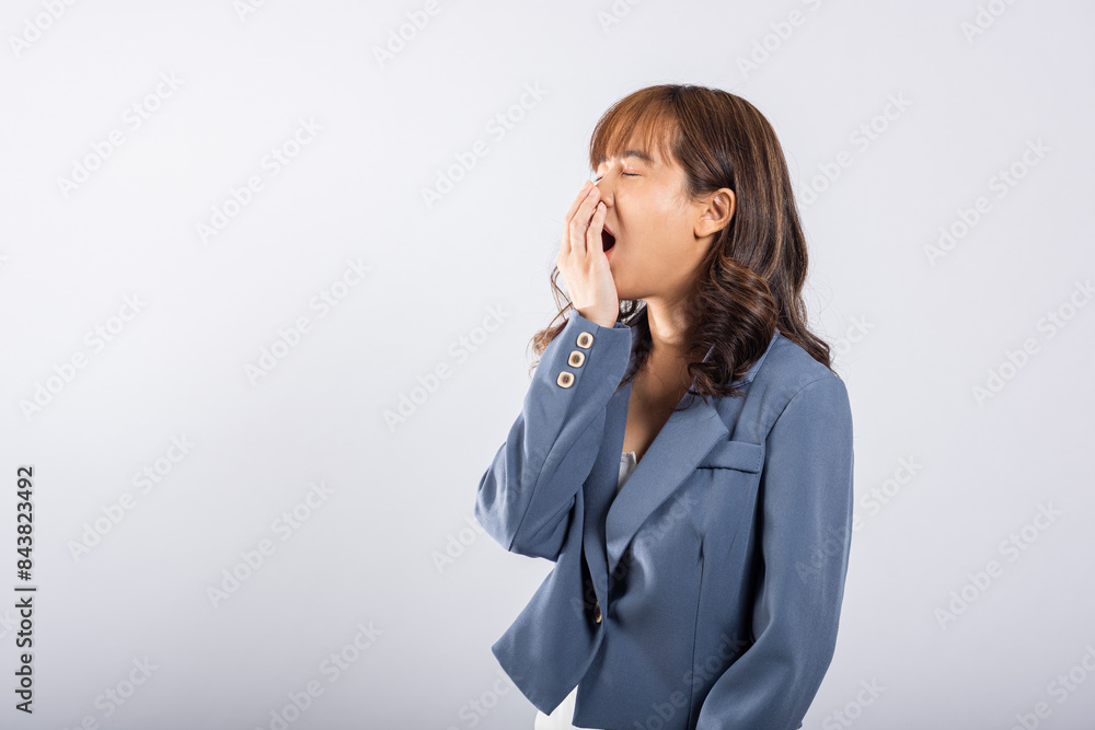 Portrait Asian beautiful young business woman emotions tired and sleepy her yawning covering mouth open by hand, studio shot isolated on white background, Female insomnia concept with copy space Portrait Asian beautiful young business woman emotions tired and sleepy her yawning covering mouth open by hand, studio shot isolated on white background, Female insomnia concept with copy space