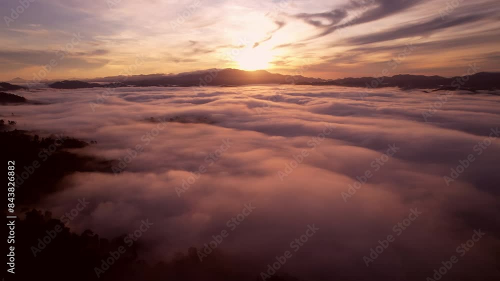 Aerial View Flying over fog in sunrise sky,Amazing sky beautiful ocean of clouds at sunrise, Sun is rising above the endless sea of clouds until the horizon, Amazing nature landscape background Aerial View Flying over fog in sunrise sky,Amazing sky beautiful ocean of clouds at sunrise, Sun is rising above the endless sea of clouds until the horizon, Amazing nature landscape background