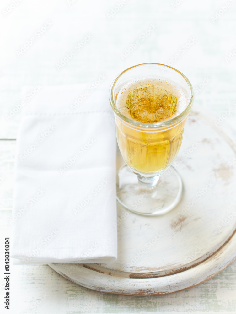 Glass of beer on bright wooden background. Copy space.	