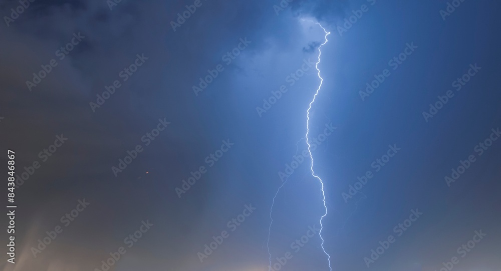 Lightning in the blue sky with clouds at night in the city. Santos city, Brazil. Lightning in the blue sky with clouds at night in the city. Santos city, Brazil.