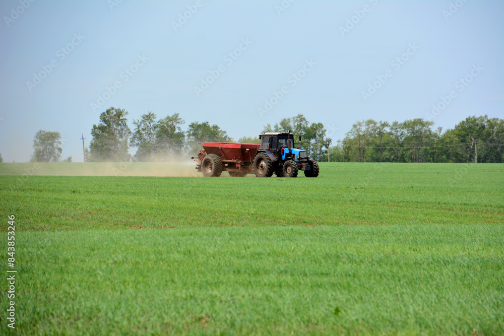 a blue tractor is plowing a field copy space a blue tractor is plowing a field copy space