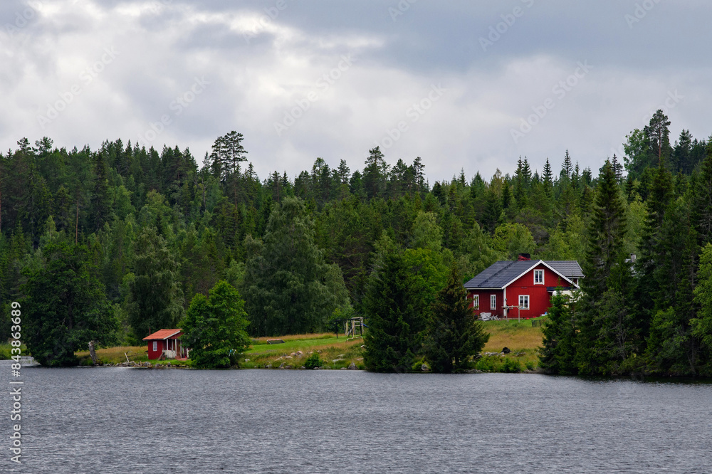 Sweden countryside. Red house in the forest near a lake. Sweden countryside. Red house in the forest near a lake.