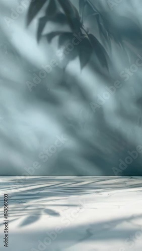Blue background with leafy green plant in foreground
