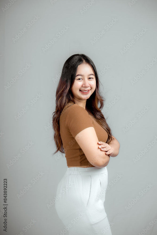 Portrait of a confident smiling girl standing with folded arms isolated. Portrait of a confident smiling girl standing with folded arms isolated.