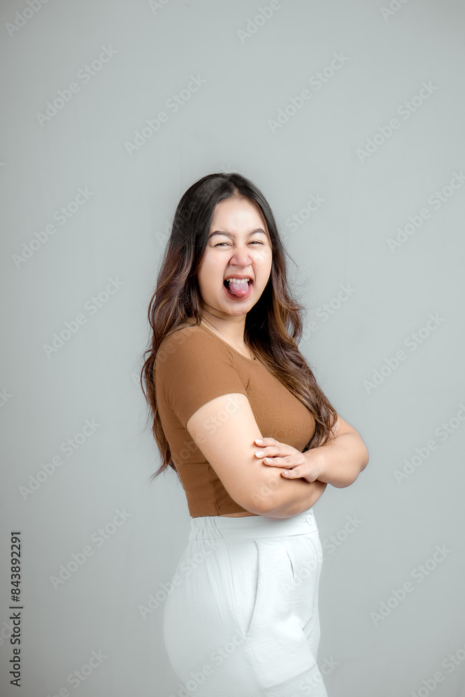 Portrait of a confident smiling girl standing with folded arms isolated. Portrait of a confident smiling girl standing with folded arms isolated.