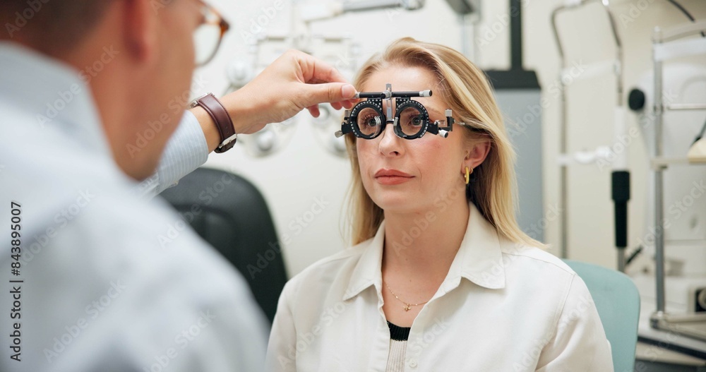 © N Lawrenson/peopleimages.com - Doctor, optometry and woman with test frame for eye care, consultation and exam in clinic. Ophthalmologist, trail and patient on lens for wellness, vision check and healthcare for eyesight correction