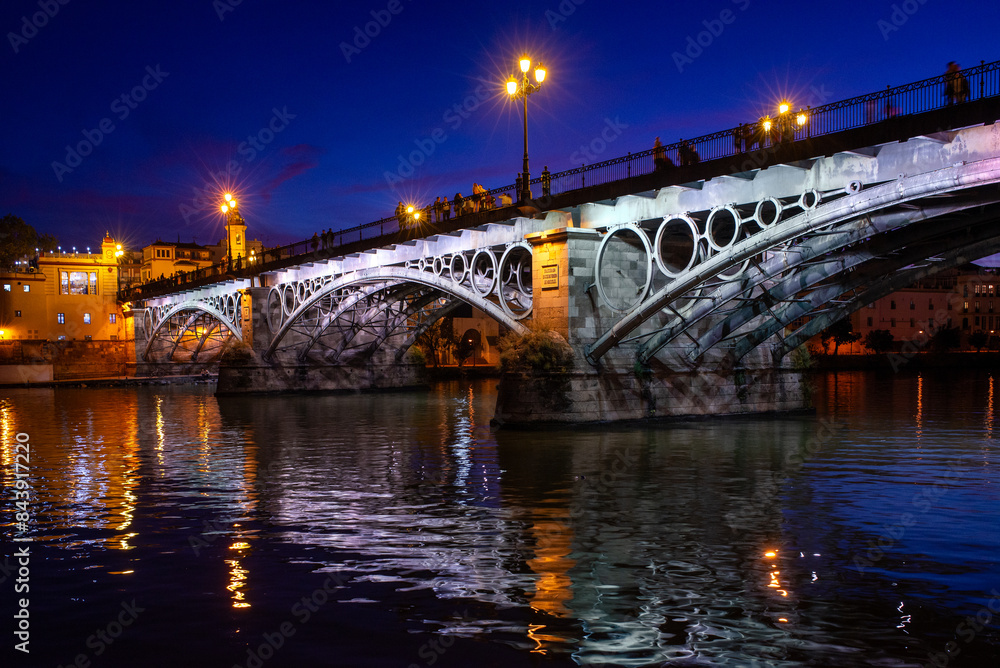 Naklejka premium Triana Bridge Over The Guadalquivir River At Nightfall, Seville