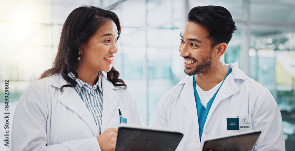 © peopleimages.com - Doctors, man and woman with tablet, meeting and check results for medical services at hospital. People, teamwork and digital touchscreen in clinical study, review and feedback at clinic in Indonesia