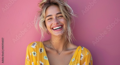 Woman In Yellow Floral Dress Smiling Against Pink Wall