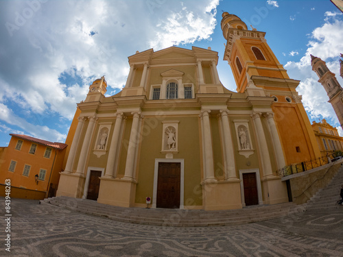 Obraz na płótnie The Basilica of Saint-Michael the Archangel in Menton, France. The tall bell tower on the right side of the church was added at the beginning of the 18th century. w salonie
