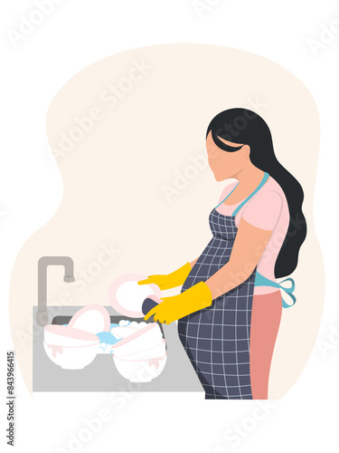 Pregnant woman doing housework, washing dishes