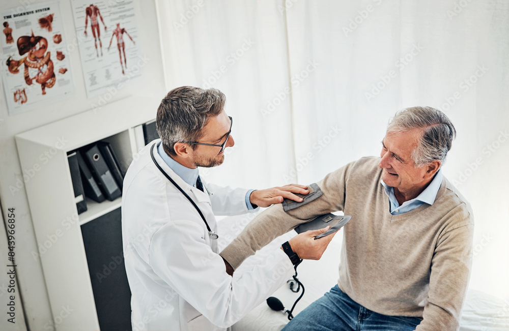 Obraz premium Blood pressure, man and doctor in office with discussion, help and advice for hypertension on bed. Clinic, senior patient and happy medical professional with support, trust and assessment at checkup