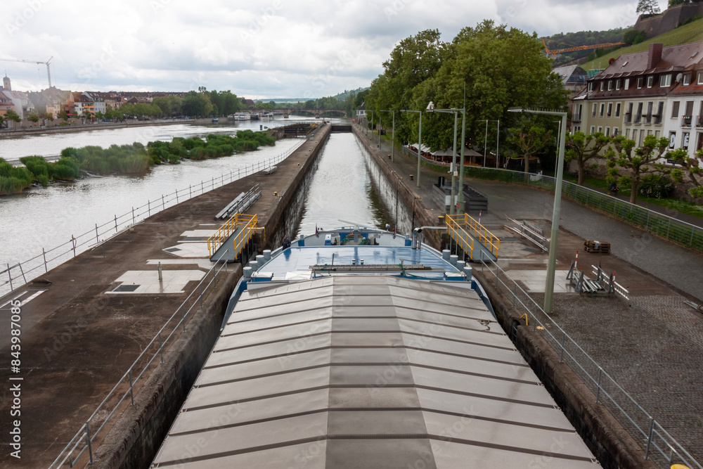 A large barge passes under the bridge, entering the lock channel A large barge passes under the bridge, entering the lock channel