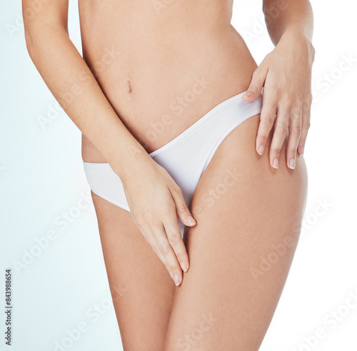 Woman, underwear and legs smooth for cosmetics, skincare and epilation in white studio background. Female person, wax or clean shave touching thigh and for health, wellness and hygiene or cellulite