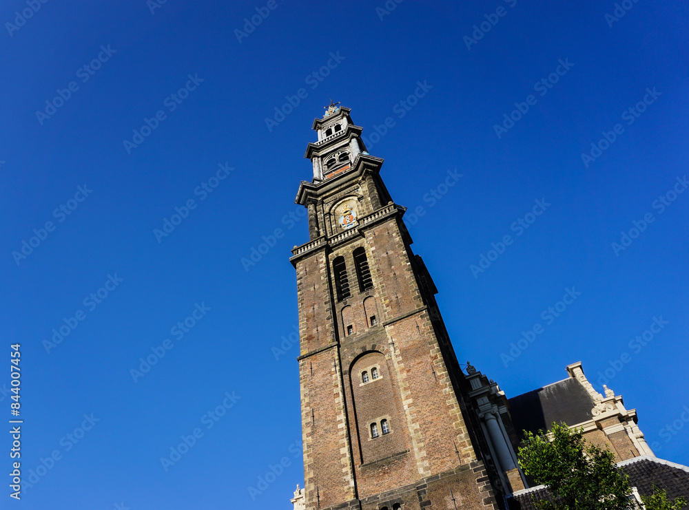 Low angle view of a church tower against blue sky Low angle view of a church tower against blue sky