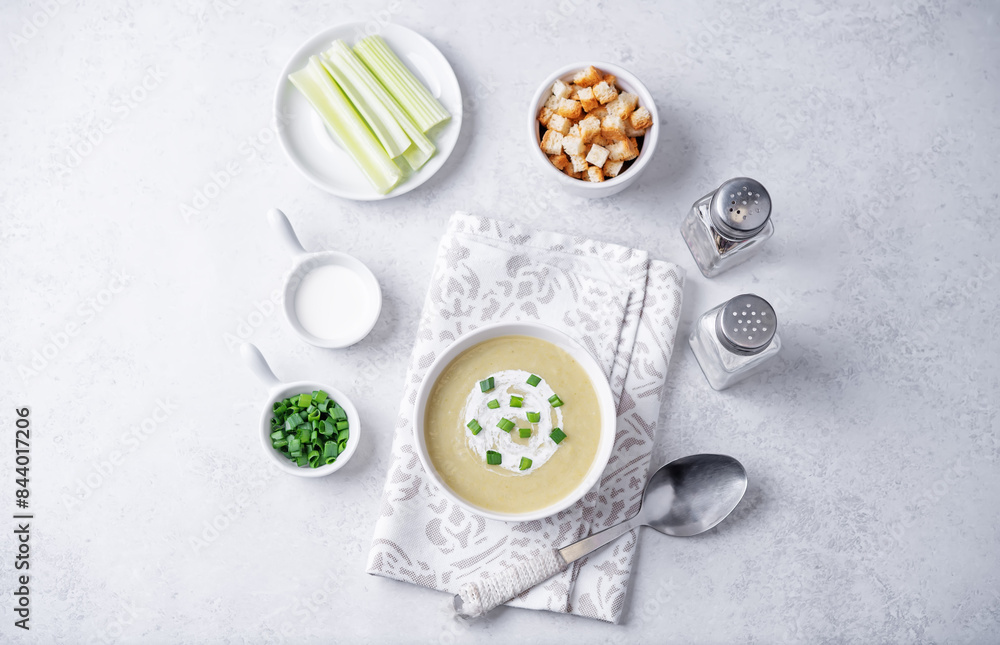 Celery greens soup with scallions and croutons in a bowl Celery greens soup with scallions and croutons in a bowl