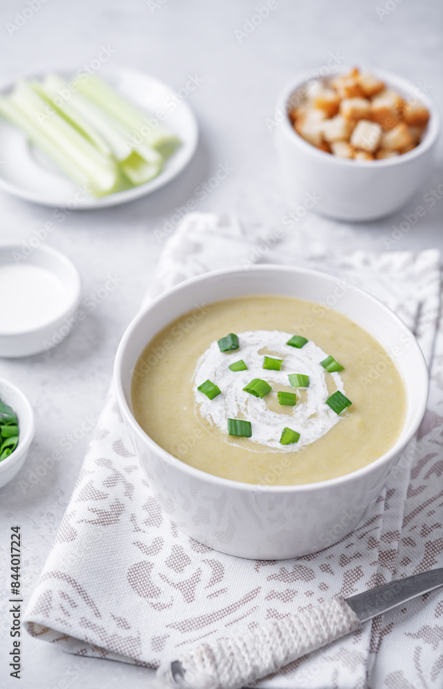 Celery greens soup with scallions and croutons in a bowl Celery greens soup with scallions and croutons in a bowl