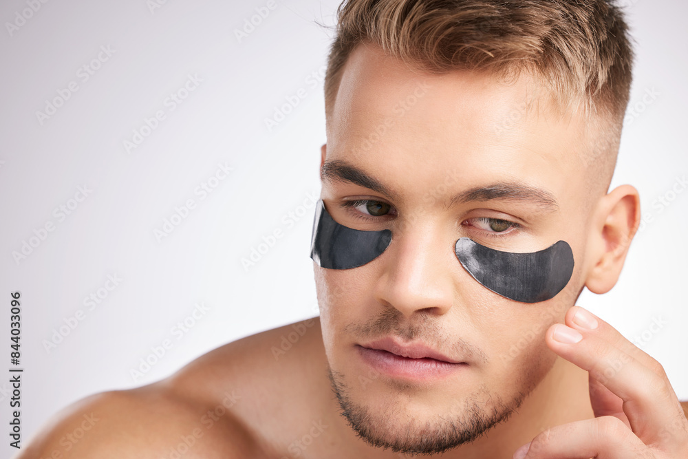 Eye mask, man and idea for dermatology for hygiene, wellness and health or skincare. Male person, thinking and cosmetics with luxury for hydration, glow and shine or detox by white background Eye mask, man and idea for dermatology for hygiene, wellness and health or skincare. Male person, thinking and cosmetics with luxury for hydration, glow and shine or detox by white background