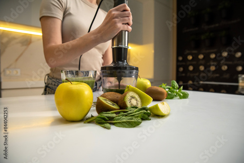 Принти на полотні Woman with immersion blender preparing a smoothie